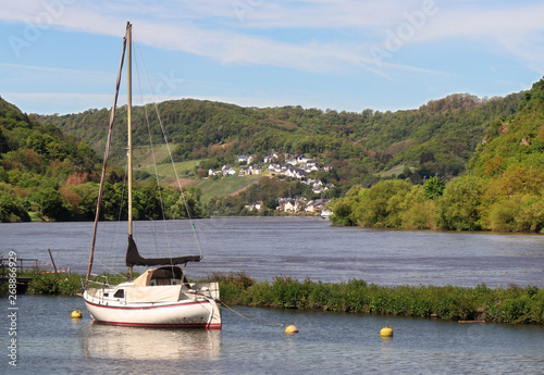 Village of Brodenbach on the banks of the Moselle river in Germany with moored boats photo