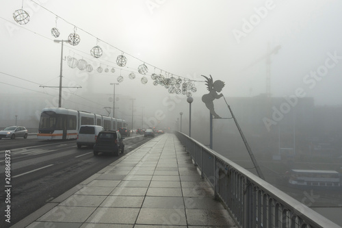 Bridge in Linz, austria covered in morning fog photo