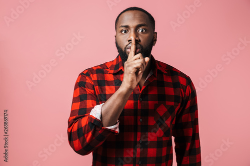 Portrait of a serious african man wearing plaid shirt