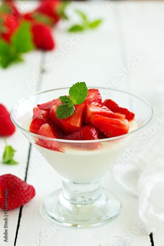 Panna cotta with strawberry sauce and mint.