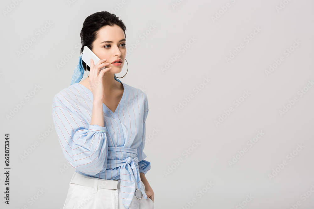 beautiful stylish girl talking on smartphone isolated on grey with copy space beautiful stylish girl talking on smartphone isolated on grey with copy space