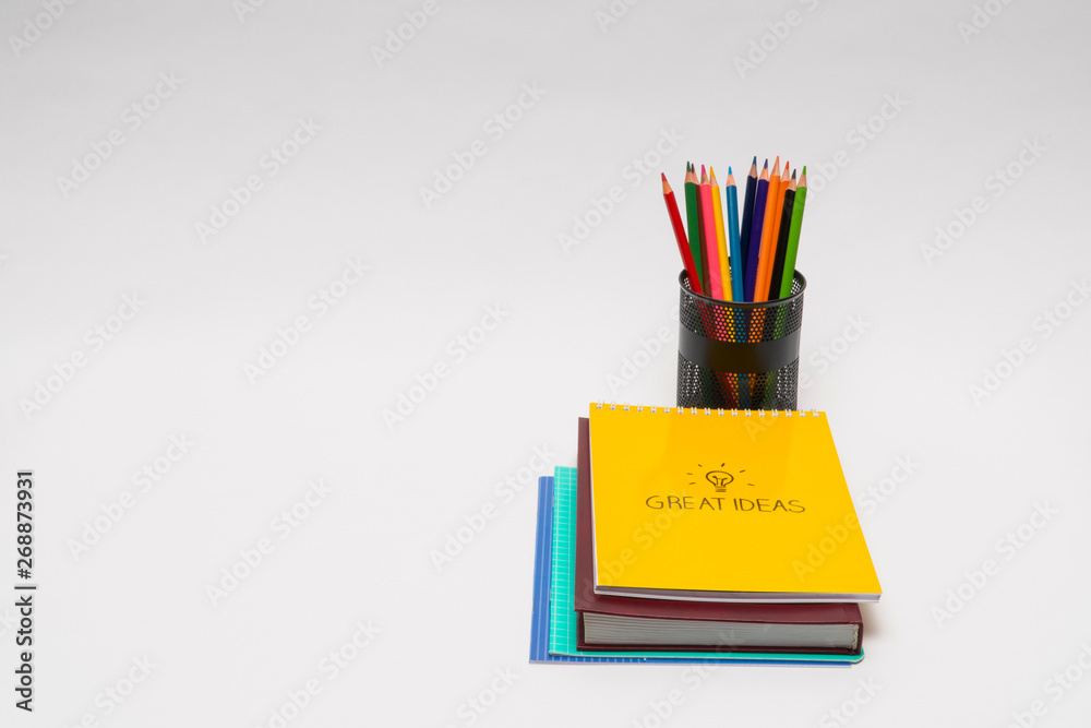 book and notepad with pencils in a basket on white background, isolated. back to school. great ideas book and notepad with pencils in a basket on white background, isolated. back to school. great ideas