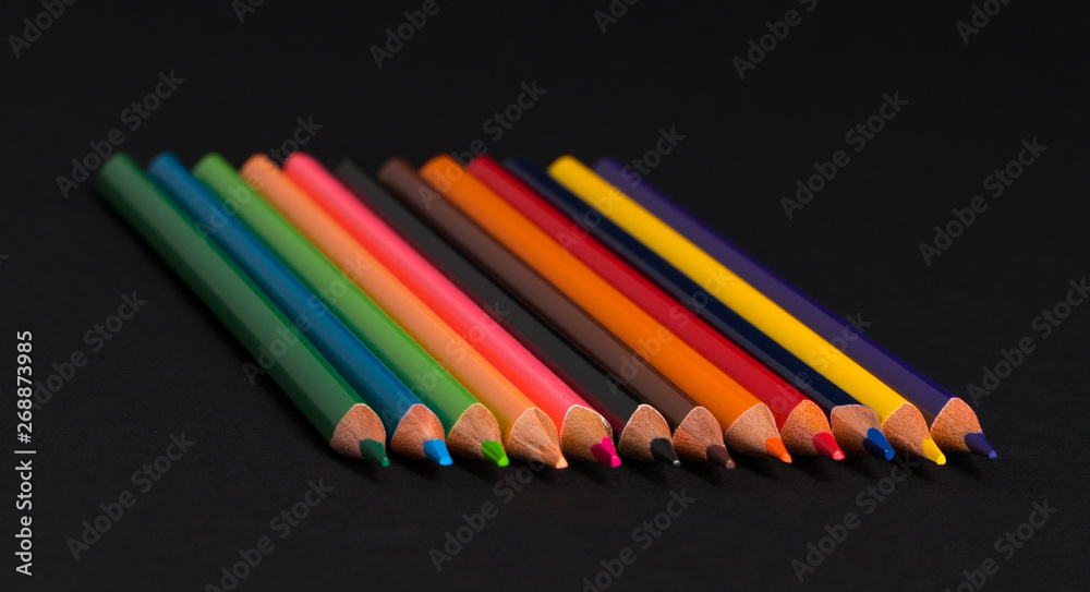 set of colored pencils on a black background isolated. back to school set of colored pencils on a black background isolated. back to school