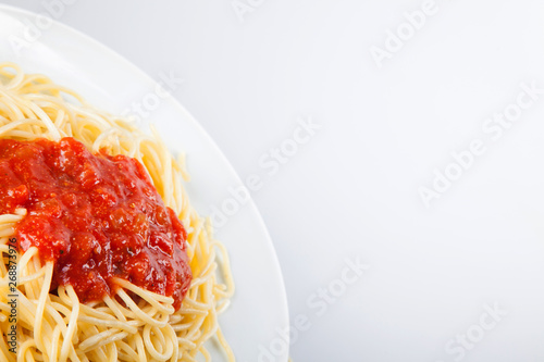 Macaroni with tomato sauce on white background