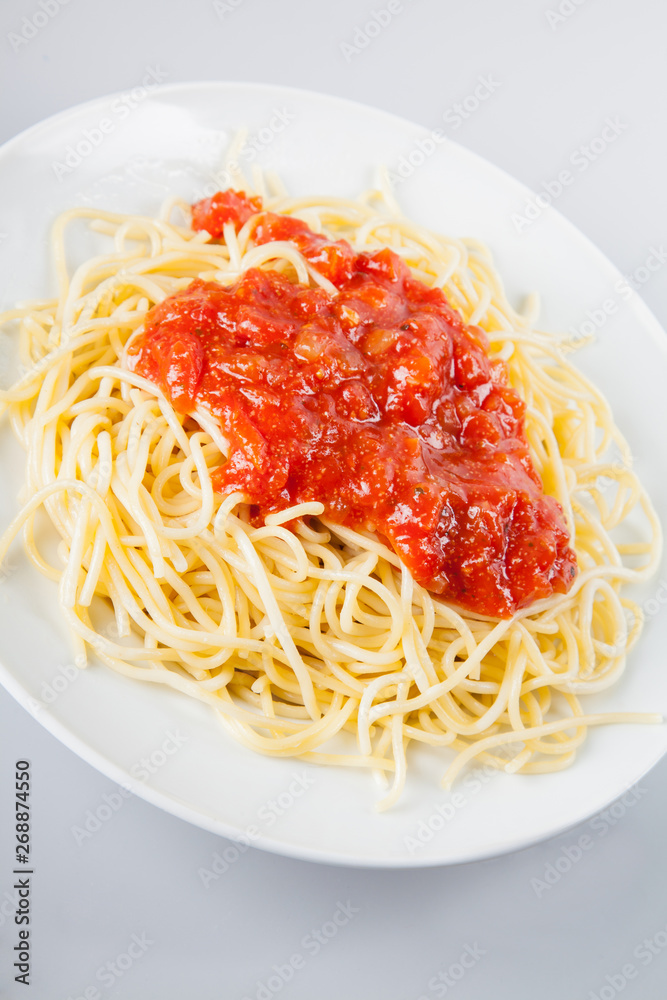 Macaroni with tomato sauce on white background Macaroni with tomato sauce on white background