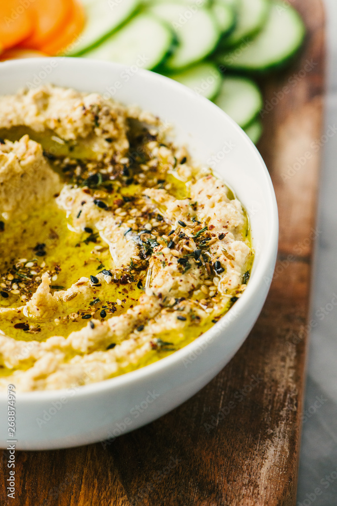 Closeup photo of cauliflower hummus with Za'atar spices and sliced vegetables Closeup photo of cauliflower hummus with Za'atar spices and sliced vegetables