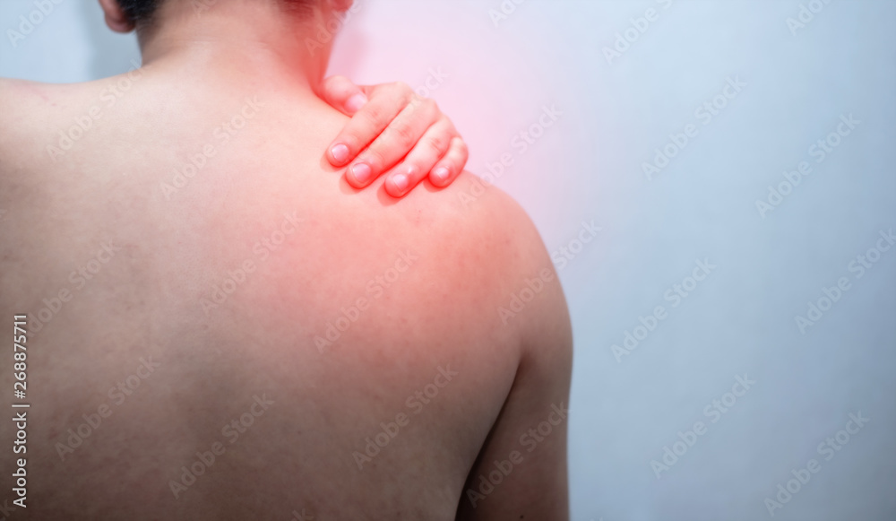 Man with pain in shoulder.  and red dot
