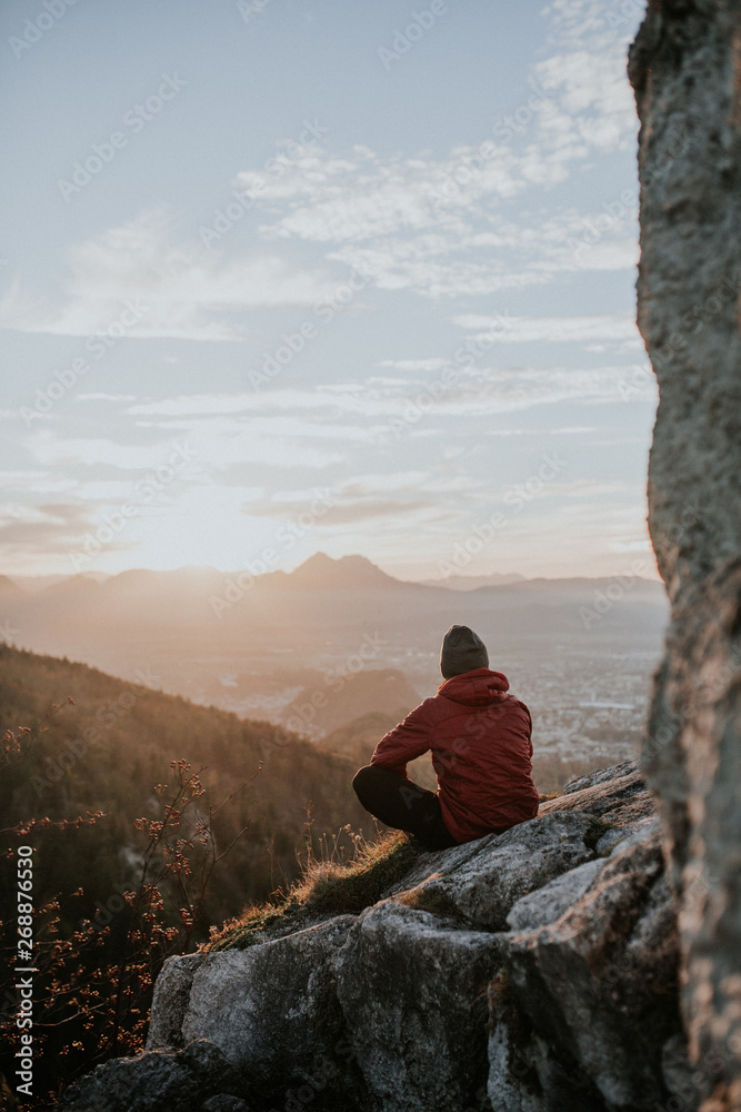 Mountain climber on summit looking at view Mountain climber on summit looking at view