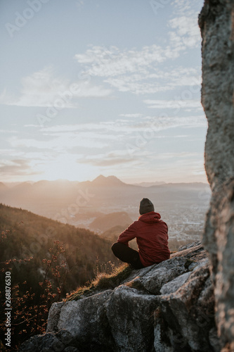Mountain climber on summit looking at view