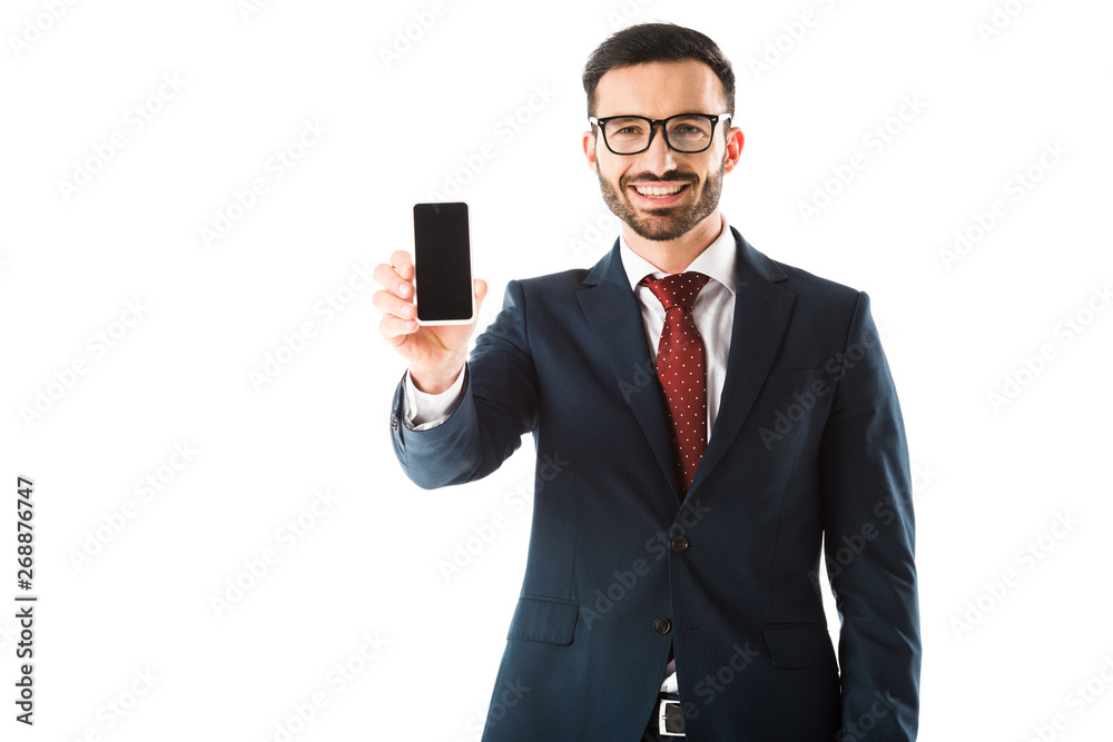cheerful businessman holding smartphone with blank screen and looking at camera isolated on white cheerful businessman holding smartphone with blank screen and looking at camera isolated on white