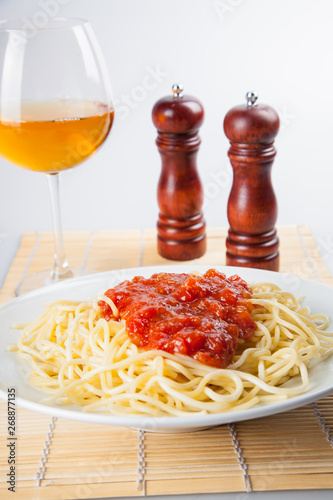 Macaroni with tomato sauce on white background