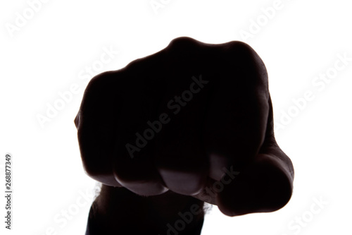 Male fist protection, opposition - silhouette photo