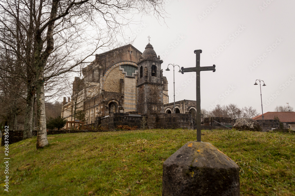 Fototapeta premium Mount Urkiola, Basque Country with Anboto mountain. Church, forest and walkers in the fog. Spain