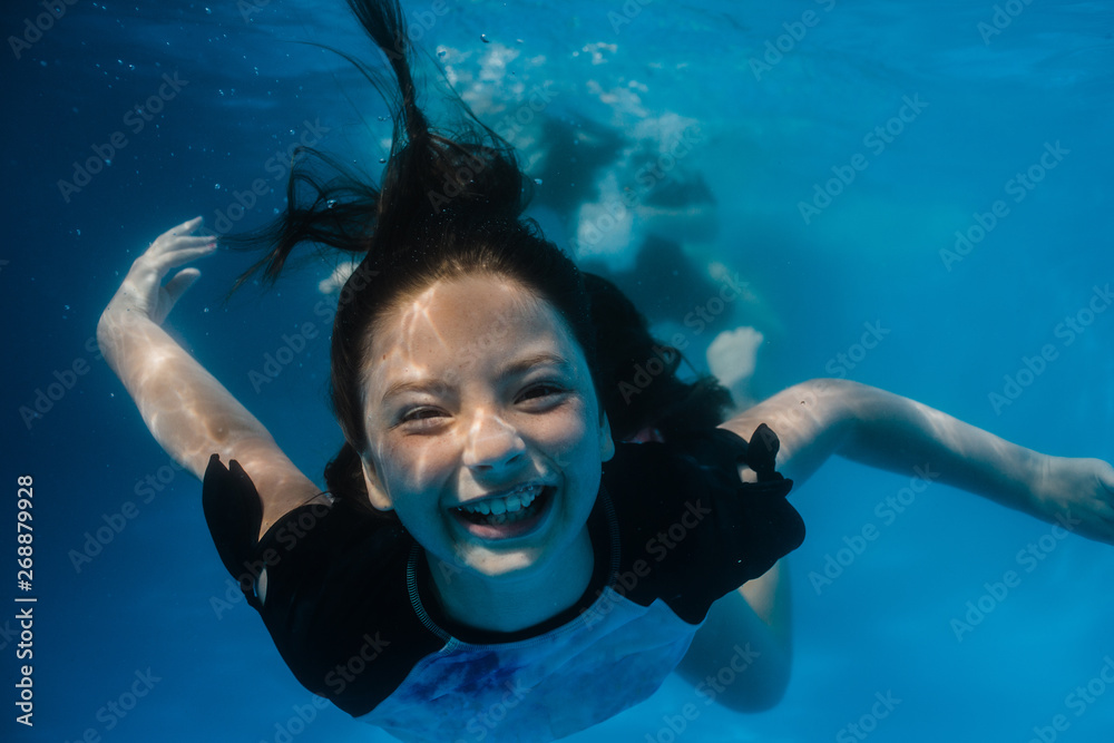 Young preteen girl having fun swimming in a pool underwater Stock Photo ...