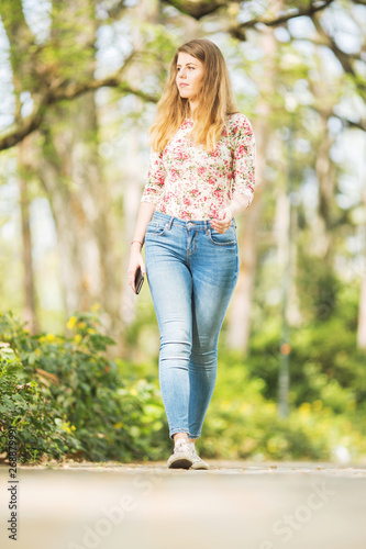 Beautiful young woman walking outdoors