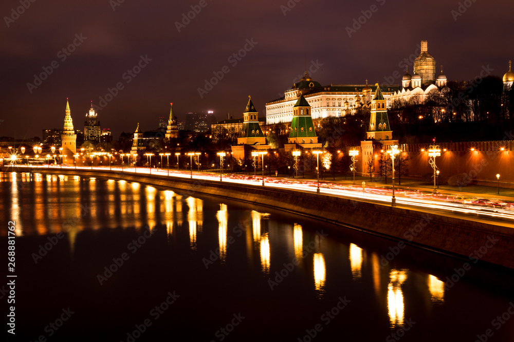 View onto illuminated Moscow Kremlin with tower during a dark winter evening with heavy traffic (Moscow, Russia, Europe)