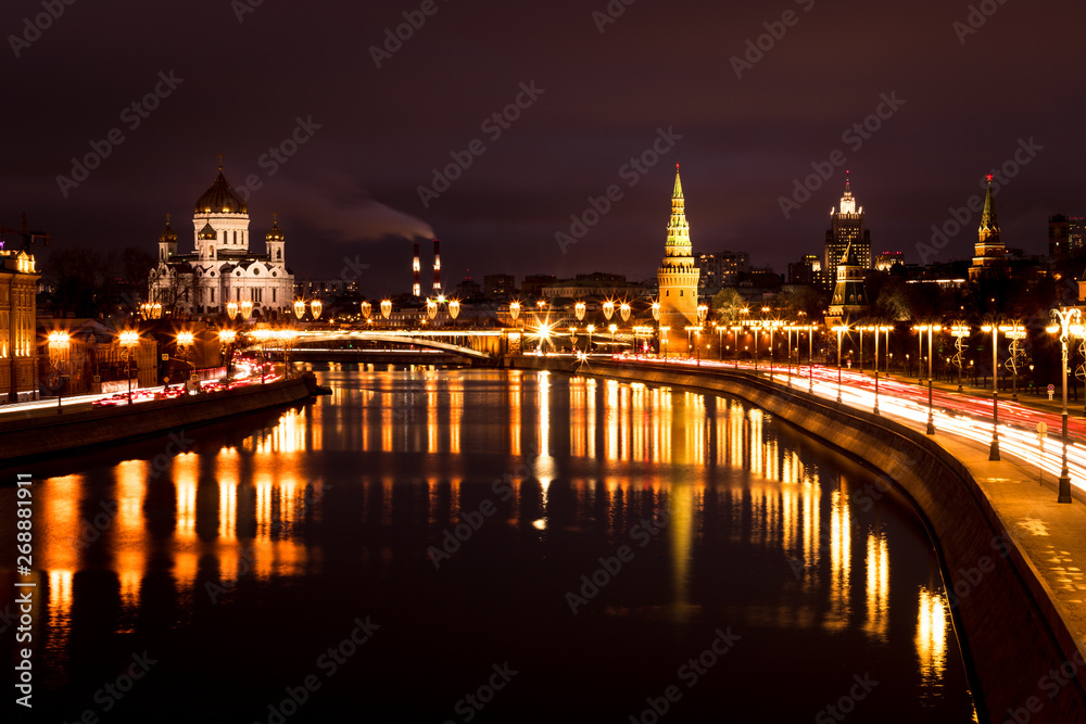View onto illuminated Moscow Kremlin with tower and Cathedral of Christ the Saviour during a dark winter evening with Moskva river (Moscow, Russia, Europe)