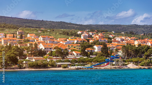Supetar city in Brac island, Croatia. View from the sea. Picturesque scenic view on Supetar on Brac island, Croatia. Panoramic view on harbor of town Supetar from the side of sea. Brac, Croatia. © daliu