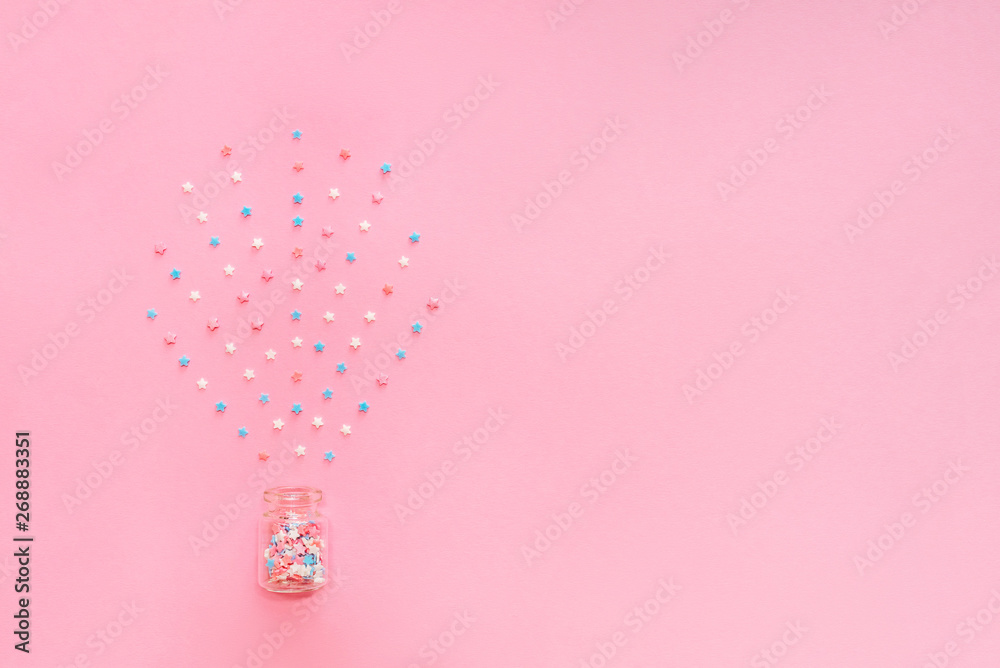 Little stars confetti on pink background. Holyday concept. Copy cpase for your text.