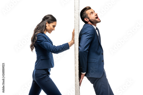 businessman and businesswoman in formal wear pushing wall isolated on white