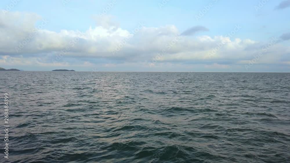 4K Video POV tracking shot side view from a passenger ferry boat as it sailing across waving sea surface from city to the island with soft white bubble under shining sunlight 4K Video POV tracking shot side view from a passenger ferry boat as it sailing across waving sea surface from city to the island with soft white bubble under shining sunlight