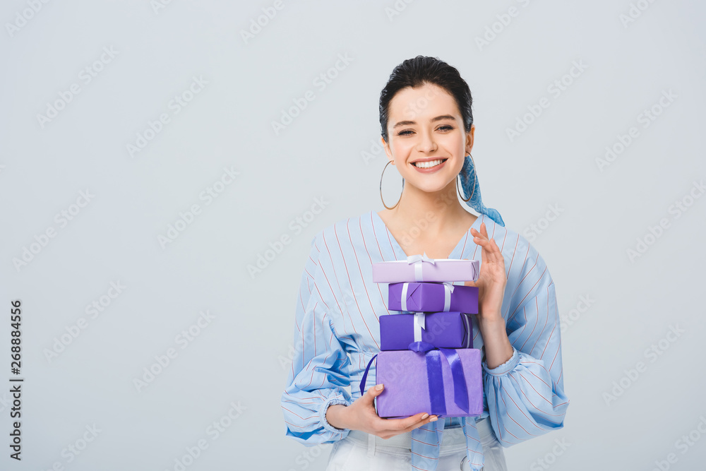beautiful stylish girl holding gift boxes and smiling isolated on grey with copy space beautiful stylish girl holding gift boxes and smiling isolated on grey with copy space