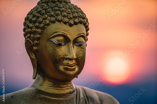 Buddhist Statue Photographed with the Red Sunset in the Background