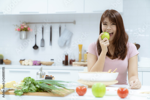 Young beautiful woman take care her health by eating salad and fruit instead of eating fat and calories