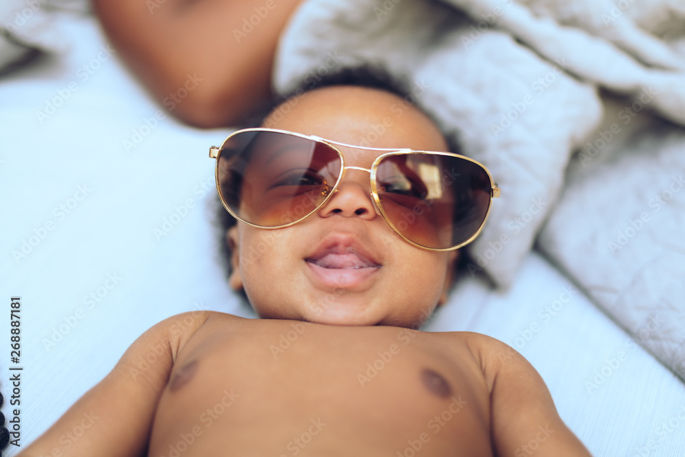 Smiling baby wears oversize sunglasses Smiling baby wears oversize sunglasses