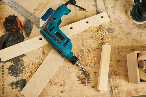 Above view background of tools and wood lying on table in carpenters workshop, copy space