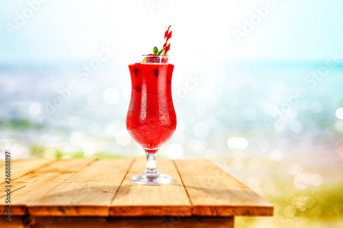 Cold summer drink on wooden table and sea landscape 