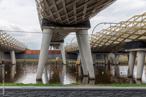 Modern railway bridge across river Dieze in Dutch city s-Hertogenbosch photo