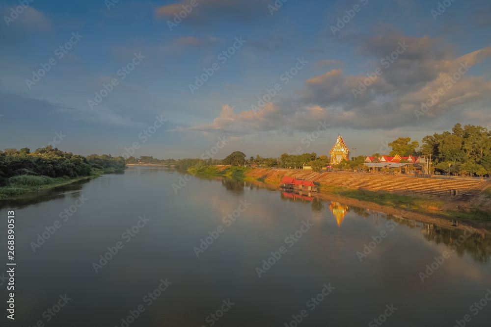 River view of Wat Yai Nakhon Chum Buddhist Temple on the bank of Mae Klong River with cloudy sky background, Nakhon Chum in Ban Pong District, Ratchaburi, Thailand. 