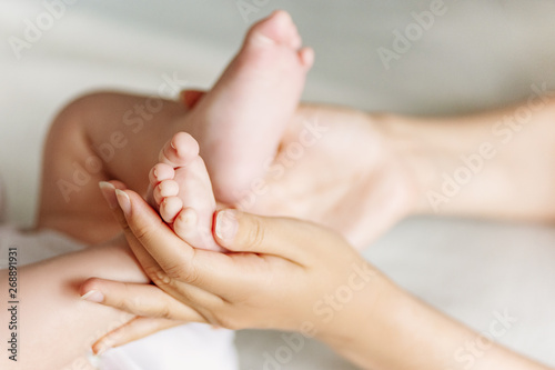 Newborn feet in mother's hands. Mother and her child concept. © Olena Bloshchynska