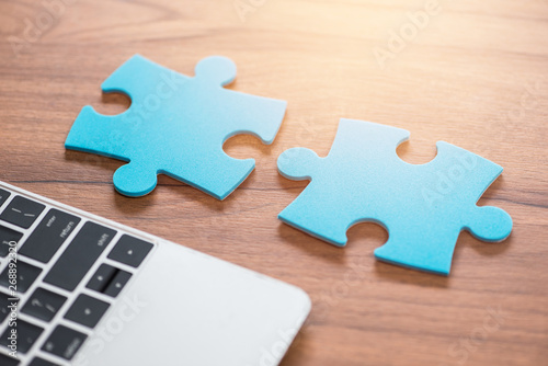 un-connect pieces of blue jigsaw puzzle on wood background
