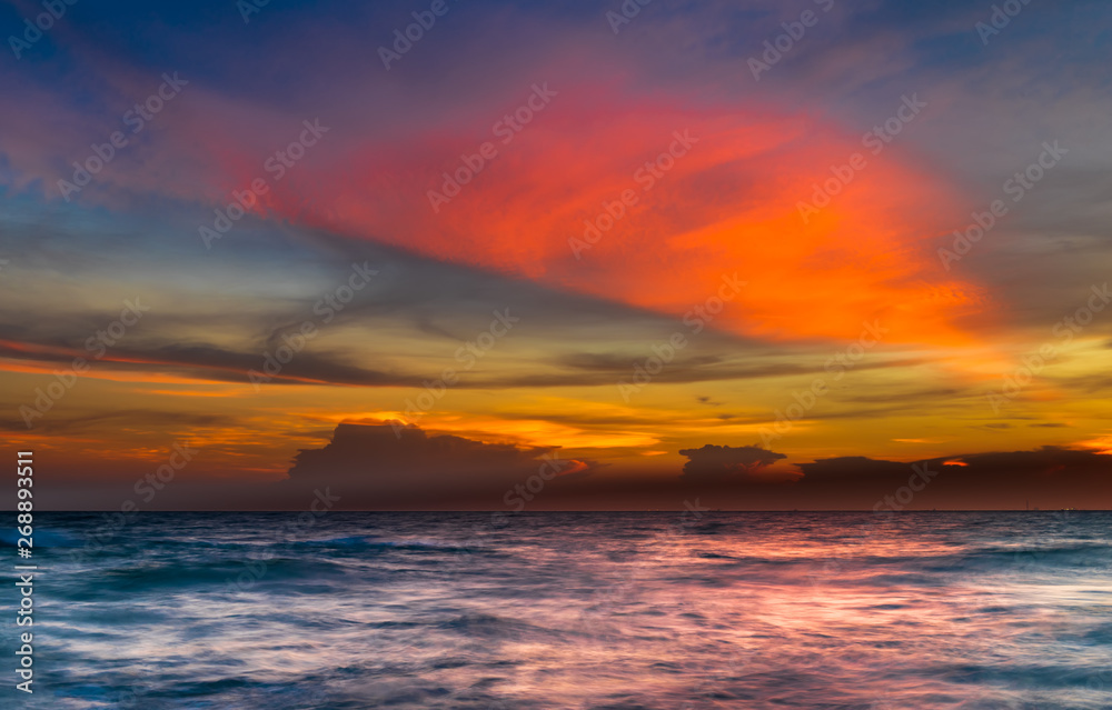 Seascape with sunset sky.