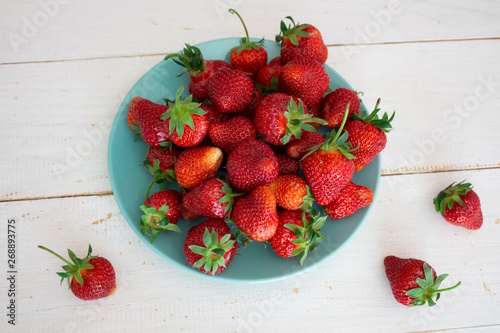 Fresh strawberries. Strawberry background. Macro texture. big, big strawberries. On a white wooden background. Harvesting clean local strawberries.