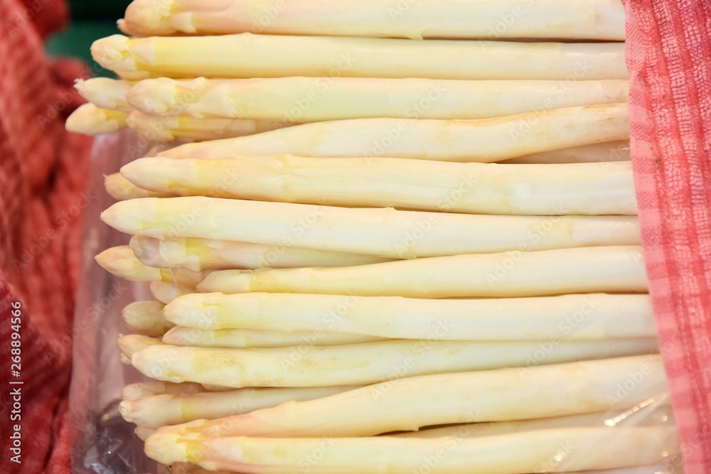 Organic white asparagus with selective focus. New eco harvest, white asparagus. Bunch of fresh ripe asparagus. Asparagus on the market stall. Dietary low-calorie vegetable. Seasonal vegetables 