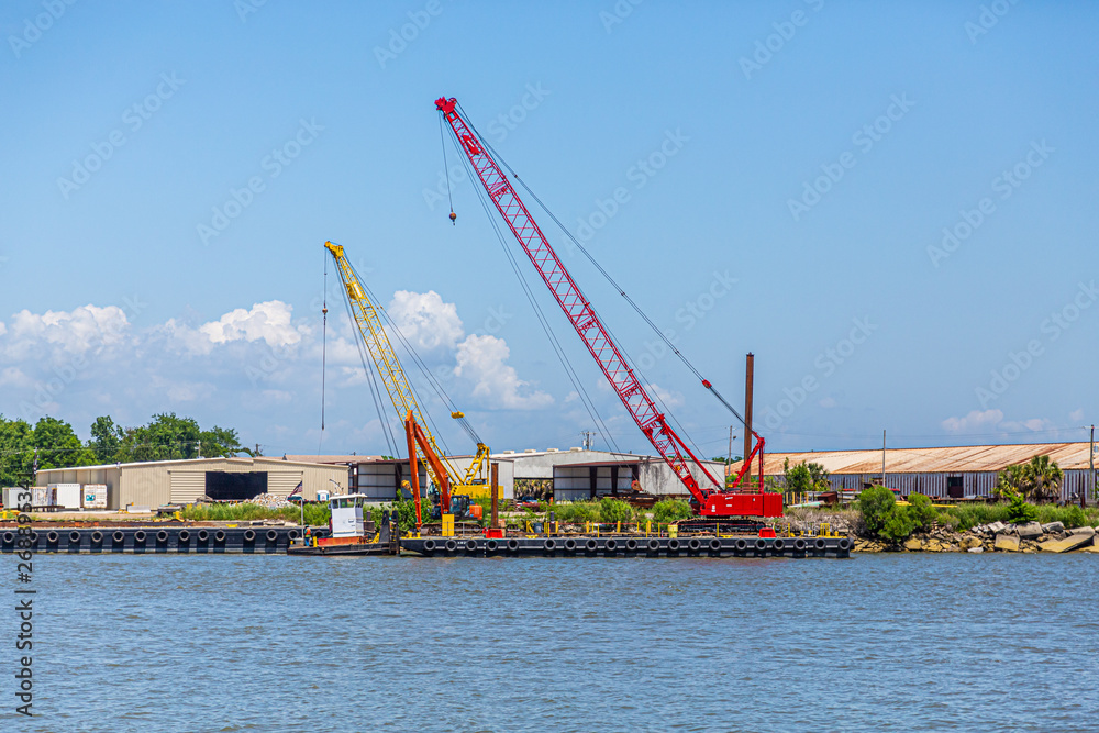 A Red and Yellow Crane on a dock on the Savannah River