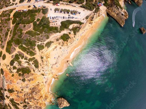 Top view on coast of Atlantic Ocean, beach and cliffs in Praia de Marinha, Algarve Portugal