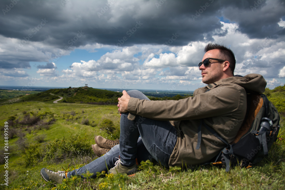 Hiker sitting on the mountain top Hiker sitting on the mountain top