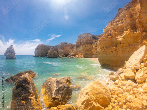 Praya de Marinha most beautiful beach in Algarve, Portugal. Cliffs on Coast of Atlantic ocean against blue sky 