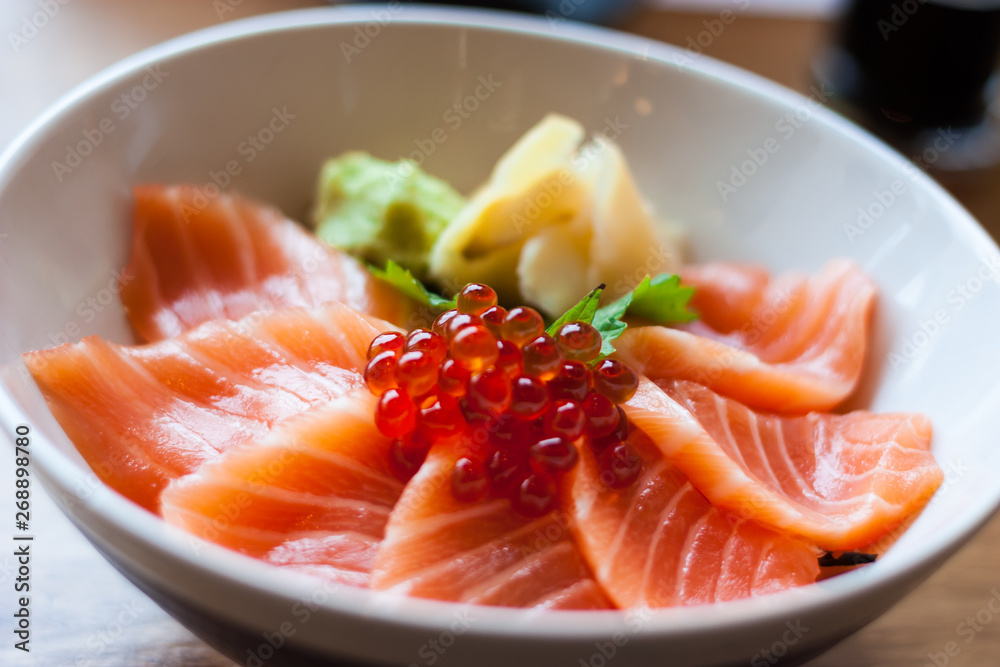 salmon sashimi put into white bowl salmon sashimi put into white bowl