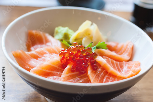 salmon sashimi put into white bowl