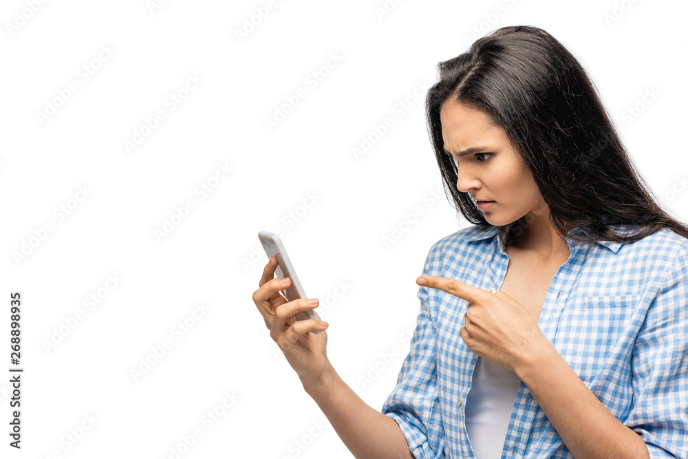 confused girl pointing with finger at smartphone Isolated On White confused girl pointing with finger at smartphone Isolated On White