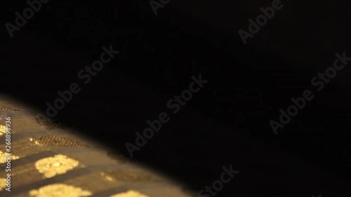 Extreme close-up low-angle still shot of a handloom weaving  flower patterns on a fabric, Uttar Pradesh, India. photo