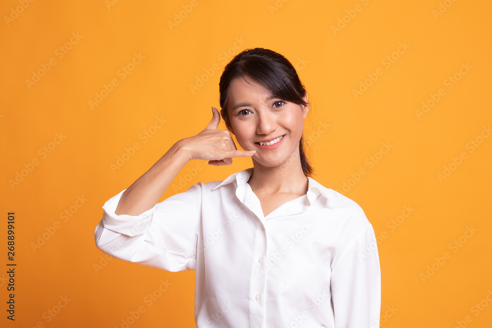 Young Asian woman show with phone gesture. Young Asian woman show with phone gesture.