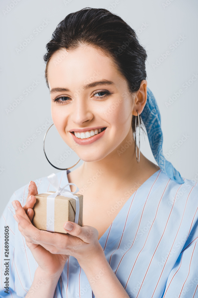 beautiful stylish girl with gift box smiling and looking at camera isolated on grey beautiful stylish girl with gift box smiling and looking at camera isolated on grey