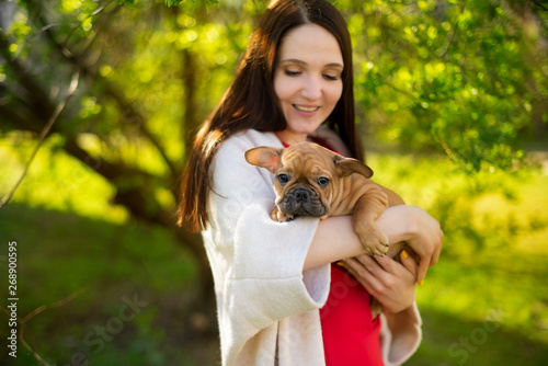 young woman with a little puppy in her arms