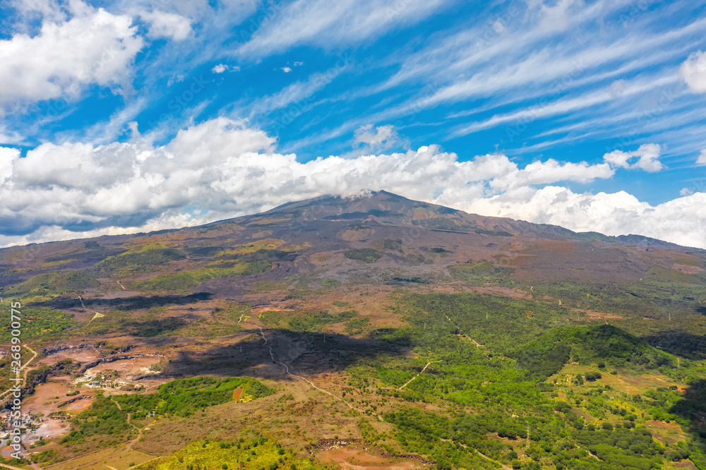 Mount Etna on the island of Sicily Italia, in good weather with picturesque clouds at the top of the volcano.